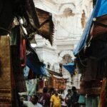 a group of people walking through a market