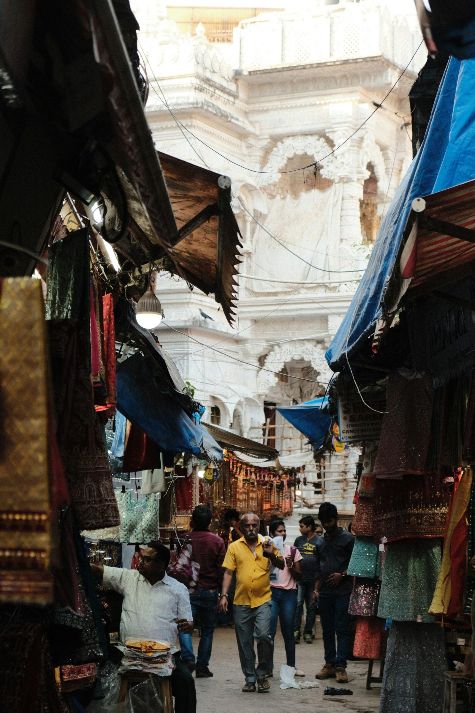 a group of people walking through a market